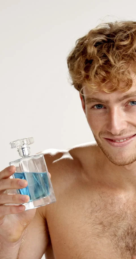 Face, man and perfume in studio for hygiene, fragrance or smile for fresh scent Stock-Footage 312401752