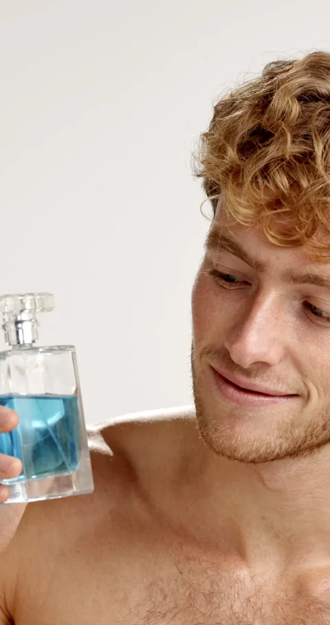 Face, man and perfume in studio for self care, essence or smile for hygiene Stock-Footage 312437385
