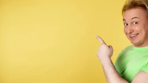 Face, man and pointing to mockup, advertising, branding in studio isolated on ye Video stock 242112854