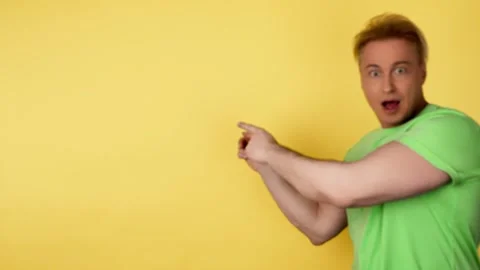 Face, man and pointing to mockup, advertising, branding in studio isolated on ye Stock-Footage 242112913