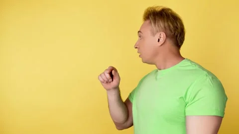 Face, man and pointing to mockup, advertising, branding in studio isolated on ye Video stock 242112984