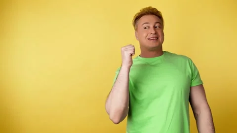 Face, man and pointing to mockup, advertising, branding in studio isolated on ye Video stock 244846187