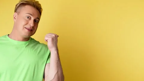 Face, man and pointing to mockup, advertising, branding in studio isolated on ye Stock Footage 244851708