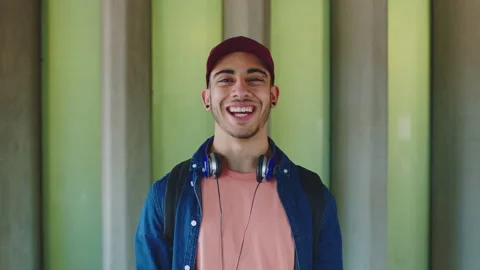 Face, man and student on college campus with laugh, headphones and funny joke Stock Footage 334758551