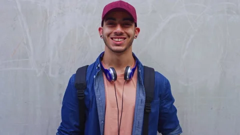 Face, man and student with smile at wall for education, scholarship and studying Stock Footage 334710984