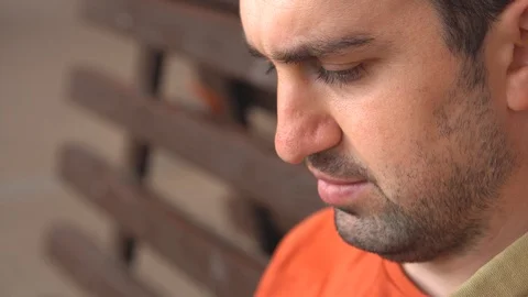 Face of man close up, who is talking on the phone video call, look down and Stock Footage 111865004