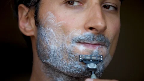 Face of the man during shaving Beard is processed by foam for shaving Hair on Stock Footage 95269769