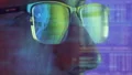 The face of the man in glasses looking on the display on the hologram background 4k or 4k+ Resolution