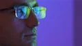The face of a man in glasses looking to the display 4k or 4k+ Resolution