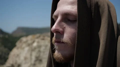 The face of a man with a hood close-up with a brooding look Stock Footage 135409361