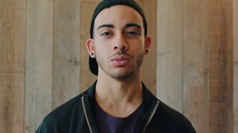 Face, man or student on wood background with streetwear fashion, creative degree Stock Footage 334758346