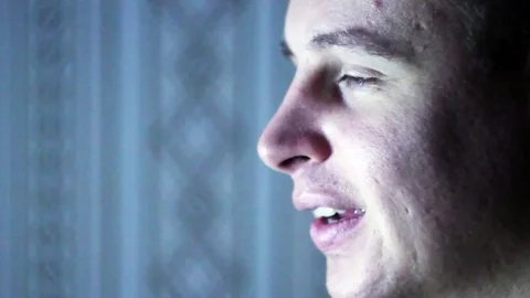 The face of man sitting at the computer 스톡 동영상 70632616