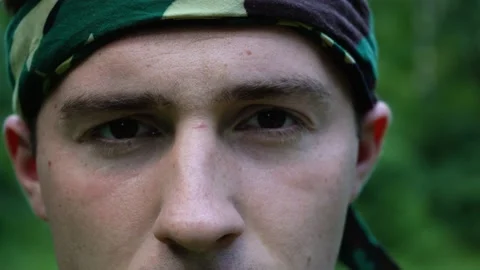 Face of a man standing in the woods close-up Video stock 155489337