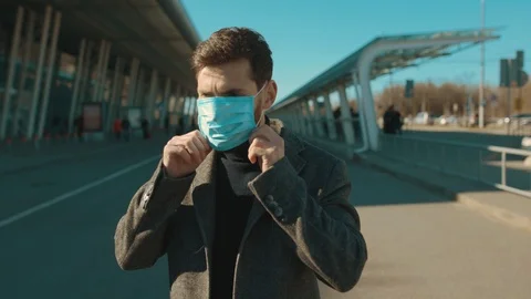 Face man wearing Protective Face Mask look at camera COVID-19 coronavirus Stock Footage 126578349