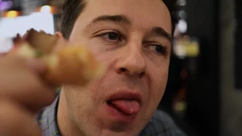 Face of man which chews pizza in cafe. Slow Stock Footage 299678801