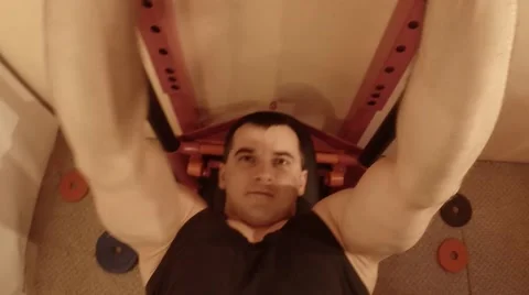 Face of a Man Who is Doing Exercises Lying With a Barbell Stock Footage 62475306