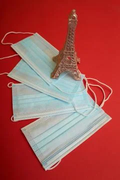 Face mask and Eiffel tower model on the red New Year background 스톡 사진