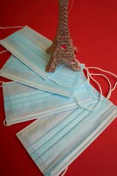 Face mask and Eiffel tower model on the red New Year background 스톡 사진