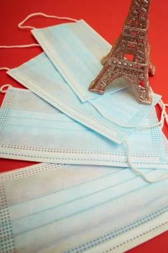 Face mask and Eiffel tower model on the red New Year background 스톡 사진