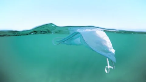 Face Mask discarded in ocean plastic pollution 4K Video stock 158087906