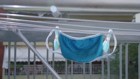 Face mask hanging on dryer. Stock Footage 142739410