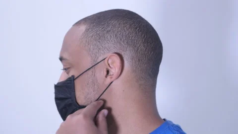 Face mask irritating ear on black man Stock Footage 135854650