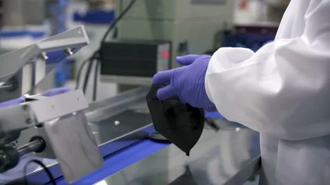 Face Mask Production - Quality control expert checks masks Stock Footage 210578696