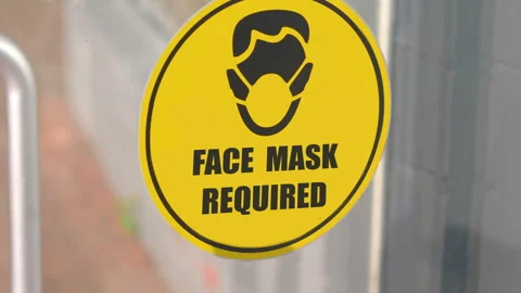 Face mask required sign on the window in 4k slow motion 60fps Stock Footage 162160278