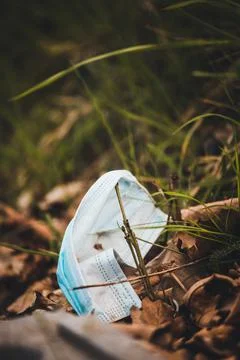 Face mask thrown on the ground Stock Photos