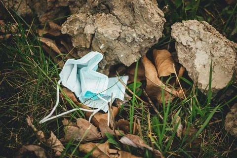 Face mask thrown on the ground Stock Photos