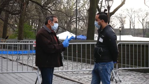 Face Masked Essential Workers Talking by Central Park Coronavirus Field Hospital Stock Footage 127924519