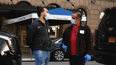 Face Masked Essential Workers Talking by Central Park Mount Sinai Hospital Stock Footage 127924521