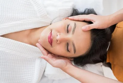 Face massage. Close-up of calm young woman getting spa massage treatment Stock Photos