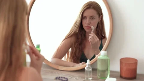 Face massage with gua sha quartz roller on cheek Stock Footage 199262971