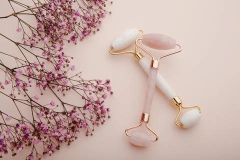 Face massage rollers on a pink background. Spa and beauty care concept Stock Photos