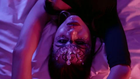 Face a model with beautiful makeup, a pattern and with rhinestones on her face Stock Footage 147578279
