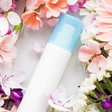 Face moisturizer in water with flowers Stock Photos