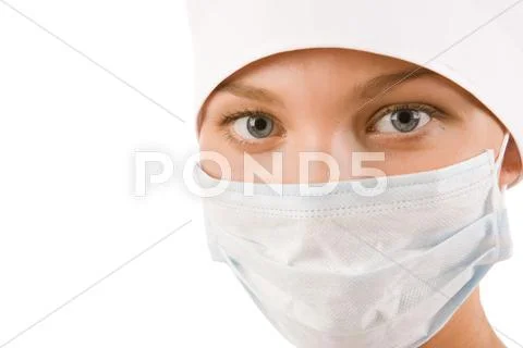 Face of nurse in sterile mask looking at camera Stock Photos