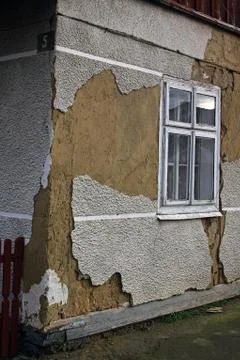 The face of an old building with ruined plaster Stock Photos