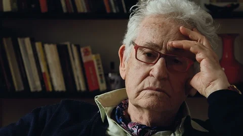 The face of an old man in the gloom expresses sadness, loneliness abandonment Video stock 89540812