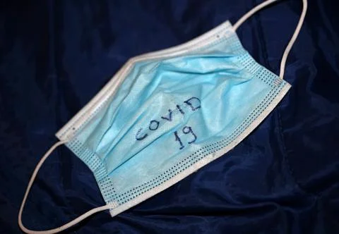 Face op mask with hand write text corona virus covid-19 macro modern backgrou Stock Photos