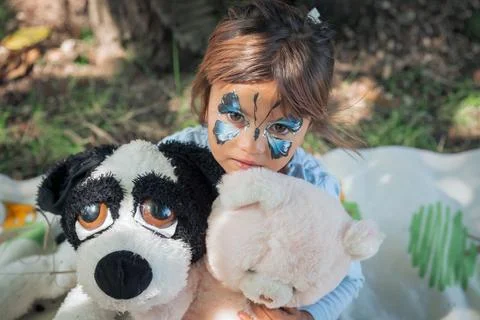 Face Painting Little Girl Butterfly holding a huge puppet dog Stock Photos