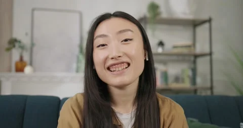 Face portrait sociable young very happy attractive asian woman video chatting Vídeos de archivo 194169702