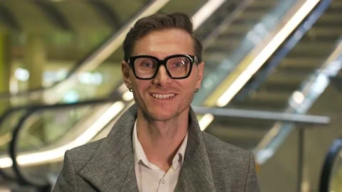 Face portrait of an yang attractive man with glasses hipster slyle looks into Stock Footage 170601372