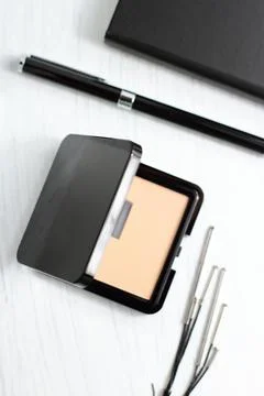 Face power in black square container on business lade table Stock Photos