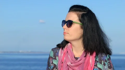 Face of pretty brown-haired young girl, standing on pier sea. Close up Stock-Footage 89576799