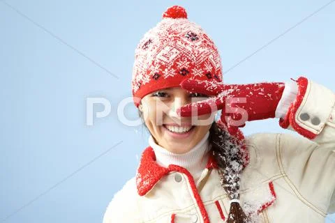 Face of pretty woman in gloves and knitted winter cap looking at camera with two Stock Photos