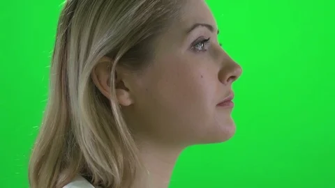 Face profile view of attractive young blond women isolated on greenscreen Video stock 72872492