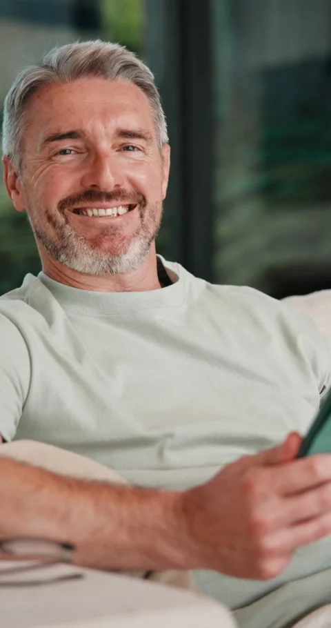 Face, relax and man with tablet on couch, weekend break and movie subscription Stock Footage 335770567