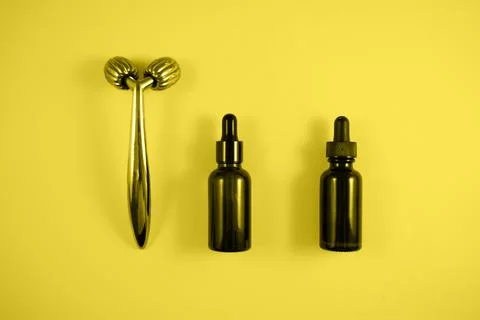 Face roller and bottle of serum Stock Photos